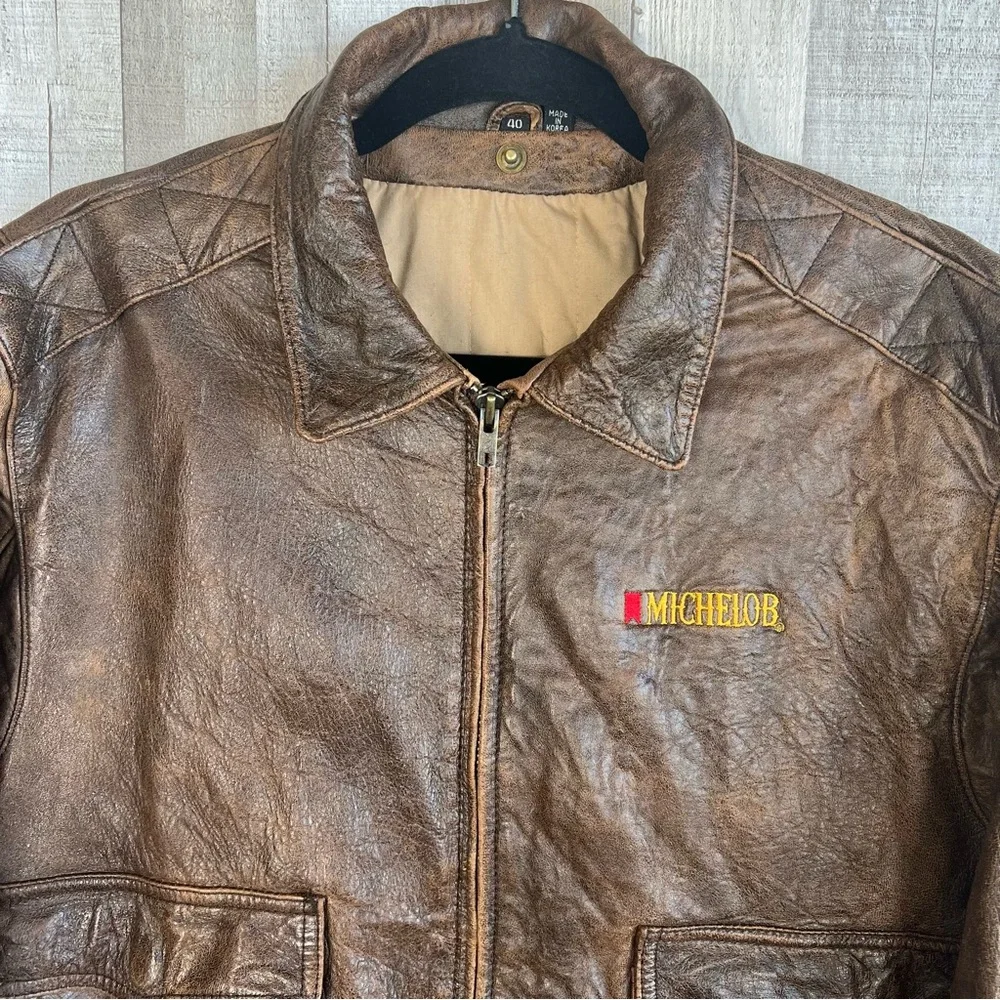 Vintage LeatherTown Bomber Aviator
Leather Jacket Size 40 Embroidered
Michelob - Picture 2 of 16